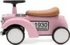 A pink ride-on toy car with a brown seat and black steering wheel, set against a white background. Produktbild-Vorschau