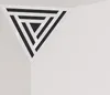 A triangular acoustic foam panel with a patterned insert, placed in the corner of a room. Podgląd zdjęcia produktu