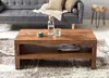 Couchtisch Durban Sheesham 110cm in Braun mit offener Ablage, Frontalansicht im Wohnzimmer. Produktbild-Vorschau