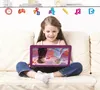 A young girl sits on a couch, holding a tablet with a Frozen-themed screen. Voir les images du produit
