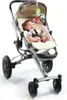 A baby sitting in a stroller with a mobile toy hanging above. Voir les images du produit