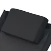 A close-up view of a black headrest cushion on a black fabric surface. Produktbild-Vorschau