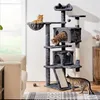 A multi-level cat tree with several cats interacting with it, placed in a living room setting. Produktbild-Vorschau