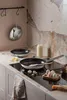 A kitchen scene with cookware and ingredients. Produktbild-Vorschau