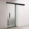 A frosted glass sliding door with a black handle and track, mounted on a light gray wall. Produktbild-Vorschau