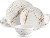 A set of white ceramic dishes with a gold marble-like pattern. Produktbild-Vorschau