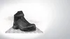 A black work boot is shown standing on a metal plate against a white and gray background. Produktbild-Vorschau