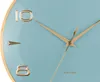 A close-up shot of a light blue analog clock with gold hands and numbers. Produktbild-Vorschau