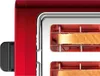 Close-up view of a red toaster with two slices of bread inside. Voir les images du produit