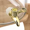 A close-up shot of a golden spigot on a glass beverage dispenser, with bamboo accents visible. Produktbild-Vorschau