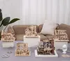 Several wooden marble run models are displayed on a table in front of a couch. Produktbild-Vorschau