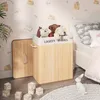 A child's bedroom with a laundry basket filled with stuffed animals next to a bed. Produktbild-Vorschau