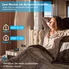 A woman is waking up in bed, with a digital alarm clock and feature callouts on the left side of the image. Produktbild-Vorschau