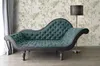 A teal chaise lounge is placed in a room with floral wallpaper and a floor lamp. Produktbild-Vorschau