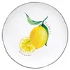 A close-up view of a plate with a lemon design. Produktbild-Vorschau