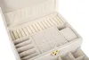 An open white jewelry box with multiple compartments and ring holders. Podgląd zdjęcia produktu