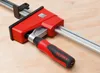 A close-up shot of a Bessey clamp on a wooden surface. Náhľad obrázku produktu