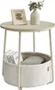 A round side table with a storage basket underneath, decorated with a framed photo and a vase with greenery on top. Náhled obrázku produktu