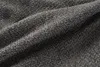 A close-up view of dark gray, coarsely woven fabric. Produktbild-Vorschau