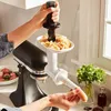 A person is using a KitchenAid stand mixer attachment to make sausages in a kitchen. Anteprima dell’immagine prodotto