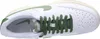 Top-down view of a white Nike sneaker with green accents and laces. Produktbild-Vorschau