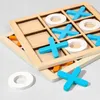 A close-up shot of a wooden tic-tac-toe game with blue X's and white O's. Náhled obrázku produktu