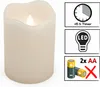 A close-up of a cream-colored LED candle with a flickering flame, accompanied by icons indicating features like a timer, LED technology, and battery requirements. Produktbild-Vorschau
