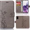 A collage of images showing a grey flip phone case with a floral pattern, including a view of the inside with card slots and a phone, and a view of the back of the case. Produktbild-Vorschau