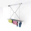 A ceiling-mounted clothes drying rack with laundry hanging on it. Podgląd zdjęcia produktu