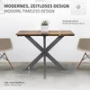 A table with a wooden top and metal legs, shown in a studio setting with chairs on either side. Náhled obrázku produktu