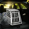 The image shows the interior of a car trunk with a dog transport box and luggage. Produktbild-Vorschau