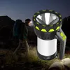 A person is hiking at night with a headlamp and carrying a large backpack. A powerful LED spotlight is in the foreground. Produktbild-Vorschau