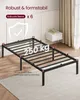 A black metal bed frame is shown on a light gray rug in a room with a white wall and a small white nightstand. Produktbild-Vorschau
