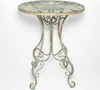 A round metal table with ornate legs and a decorative top, shown against a white background. Náhled obrázku produktu