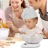 A family baking in the kitchen, with a child using a digital scale. Voir les images du produit