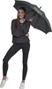 A woman is posing with an umbrella. Produktbild-Vorschau