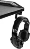A close-up of a black gaming headset hanging from a black desk mount. Produktbild-Vorschau