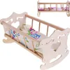A wooden doll cradle with bedding, shown from a slightly elevated angle. Náhľad obrázku produktu