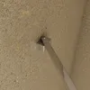 A close-up view of a shower wall bracket attached to a textured wall. Produktbild-Vorschau