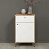A white and wood-tone cabinet with a geometric pattern on the door, placed against a gray wall. Voir les images du produit