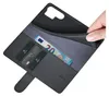 A hand is holding open a black leather wallet-style phone case, revealing credit cards and a 20 Euro banknote. Produktbild-Vorschau