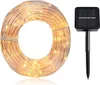 A coiled string of solar-powered LED lights and a separate solar panel with a stake. Produktbild-Vorschau