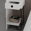 A close-up view of a modern white nightstand with an open drawer and books on a shelf. Podgląd zdjęcia produktu