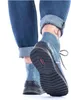 A close-up shot of a person wearing blue jeans and blue boots. Produktbild-Vorschau