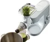 A Kenwood juicer attachment is shown processing wheatgrass into juice, with the juice collecting in a glass and a bowl. Anteprima dell’immagine prodotto