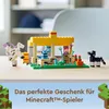 A LEGO Minecraft horse stable playset with figures and accessories, set on a wooden surface with a blurred background. Podgląd zdjęcia produktu