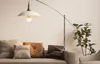 A living room scene with a sofa, pillows, a floor lamp, and a plant. Náhled obrázku produktu
