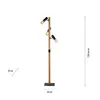 A floor lamp with three adjustable spotlights on a wooden pole, shown against a white background with measurement indicators. Produktbild-Vorschau