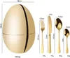 A golden egg-shaped cutlery set holder with individual cutlery pieces displayed next to it, along with size and weight measurements. Produktbild-Vorschau