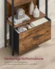 A close-up view of a shelf in a bookshelf, showing a drawer with a wooden front and a black handle. Inside the drawer, headphones are visible. Above the drawer, there are books and decorative items. Produktbild-Vorschau